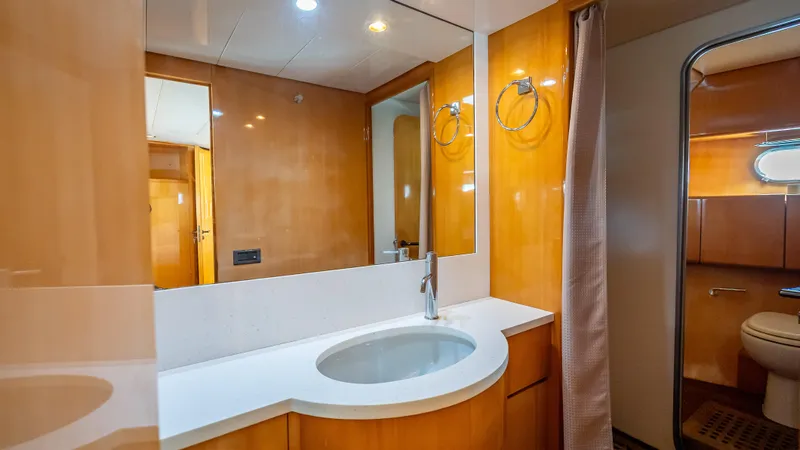 Bramamare Yacht Photos Pics Luxurious bathroom in 1995 Sanlorenzo 62 yacht with modern fixtures and wood paneling.