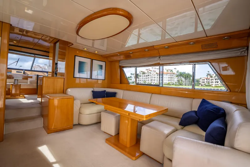 Bramamare Yacht Photos Pics Luxurious interior of a 1995 Sanlorenzo 62 yacht with elegant seating and wood finishes.