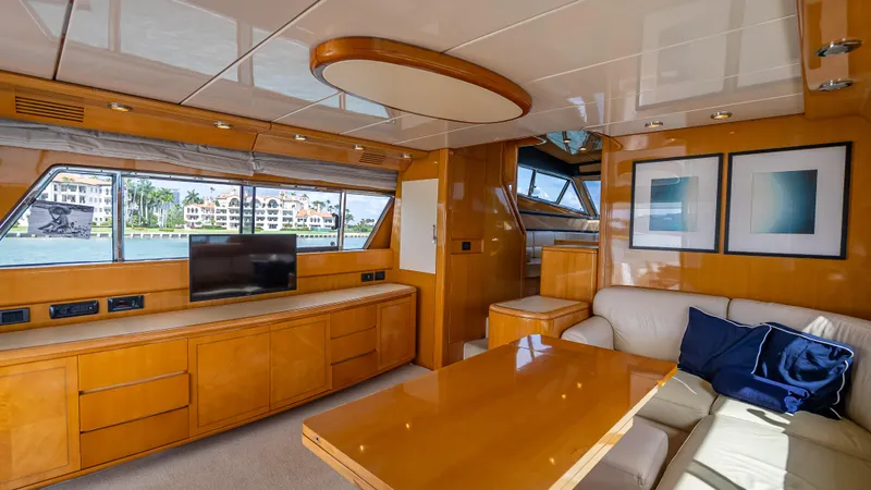 Bramamare Yacht Photos Pics Luxurious interior of a 1995 Sanlorenzo 62 yacht with wood finishes and modern decor.