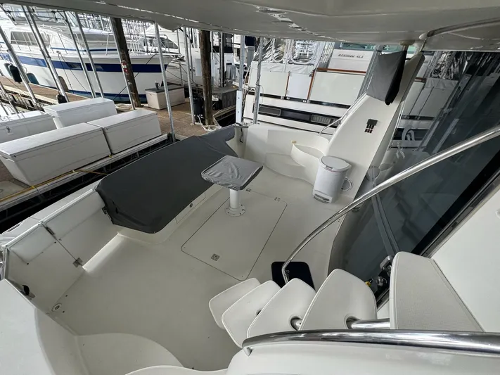 Cloud 9 Yacht Photos Pics 2004 Carver 56 Voyager yacht deck with seating and table, docked at marina.