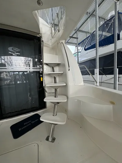 Cloud 9 Yacht Photos Pics Interior of 2004 Carver 56 Voyager yacht with spiral staircase and "Remove Shoes" mat.