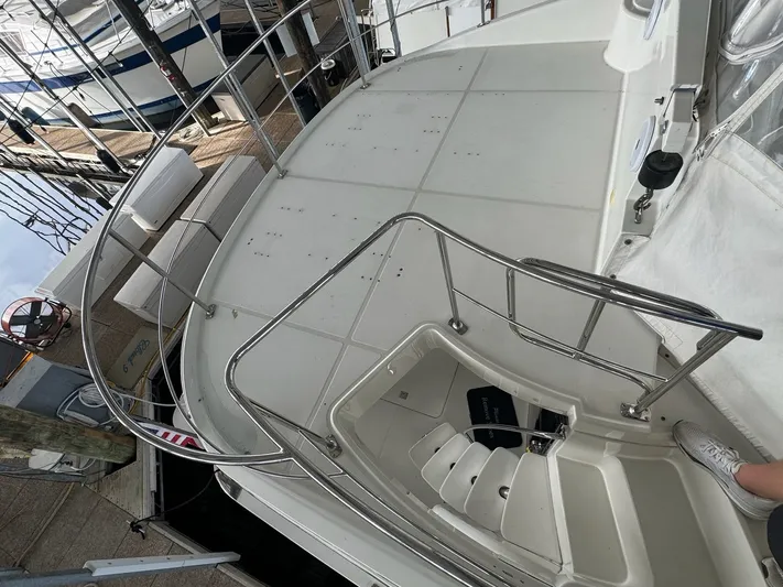 Cloud 9 Yacht Photos Pics 2004 Carver 56 Voyager yacht deck with stainless steel railings and dock view.