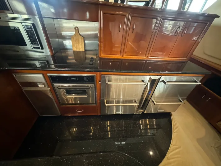 Cloud 9 Yacht Photos Pics Luxurious kitchen in 2004 Carver 56 Voyager yacht with stainless steel appliances and wooden cabinetry.