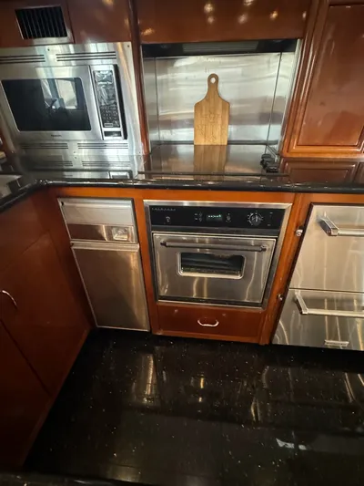 Cloud 9 Yacht Photos Pics Luxurious kitchen in 2004 Carver 56 Voyager yacht with modern appliances and wood cabinetry.