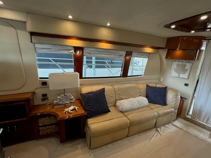 Cloud 9 Yacht Photos Pics Luxurious interior of 2004 Carver 56 Voyager yacht with beige leather sofa and elegant decor.