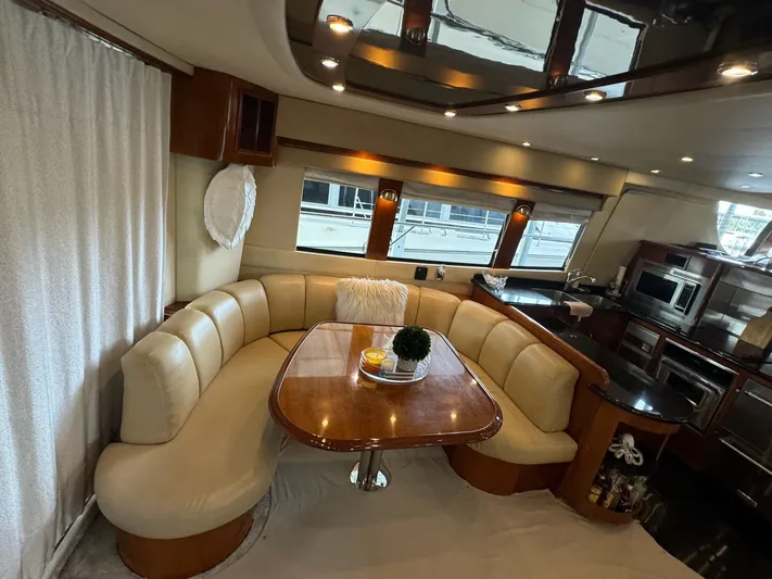 Cloud 9 Yacht Photos Pics Luxurious interior of 2004 Carver 56 Voyager yacht with elegant dining area and modern kitchen.