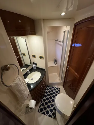 Cloud 9 Yacht Photos Pics Luxurious bathroom in 2004 Carver 56 Voyager yacht with shower, sink, and toilet.