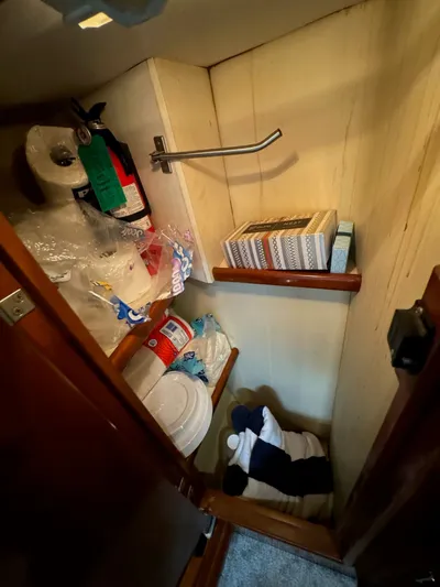 Cloud 9 Yacht Photos Pics Storage closet in 2004 Carver 56 Voyager yacht with supplies and fire extinguisher.