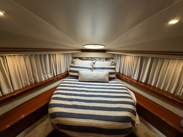 Cloud 9 Yacht Photos Pics Luxurious bedroom interior of 2004 Carver 56 Voyager yacht with striped bedding.