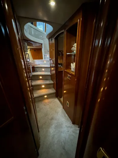 Cloud 9 Yacht Photos Pics Luxurious interior of 2004 Carver 56 Voyager yacht with carpeted stairs and wooden cabinetry.