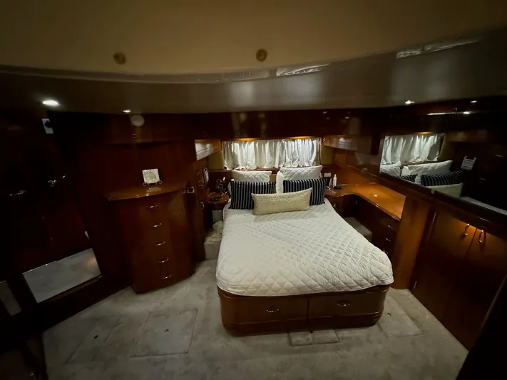 Cloud 9 Yacht Photos Pics Luxurious bedroom interior of 2004 Carver 56 Voyager yacht with elegant wood finishes.