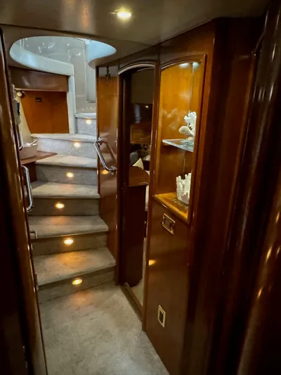 Cloud 9 Yacht Photos Pics Interior of 2004 Carver 56 Voyager yacht with elegant wood finish and carpeted stairs.