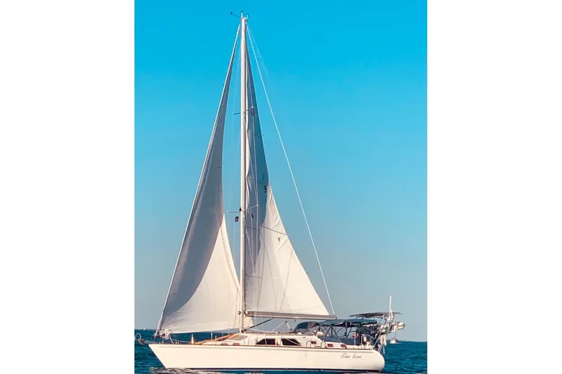 True Love Yacht Photos Pics Sailing yacht Catalina Morgan 440 DS 2005 on open sea under clear blue sky.