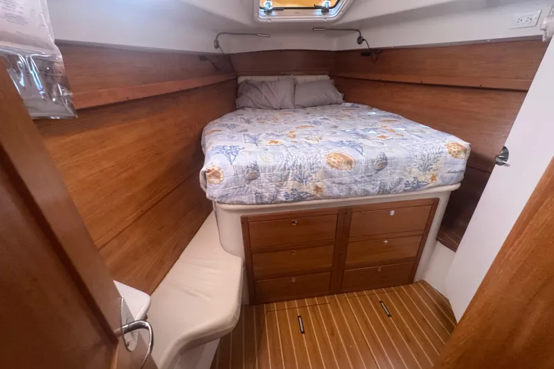 True Love Yacht Photos Pics Cozy cabin interior of 2005 Catalina Morgan 440 DS sailboat with wooden finish and bed.