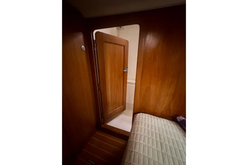 True Love Yacht Photos Pics Interior of 2005 Catalina Morgan 440 DS yacht, featuring wooden door and cozy cabin space.