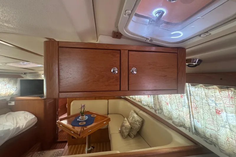 True Love Yacht Photos Pics Interior of 2005 Catalina Morgan 440 DS yacht with wooden cabinetry and cozy seating area.