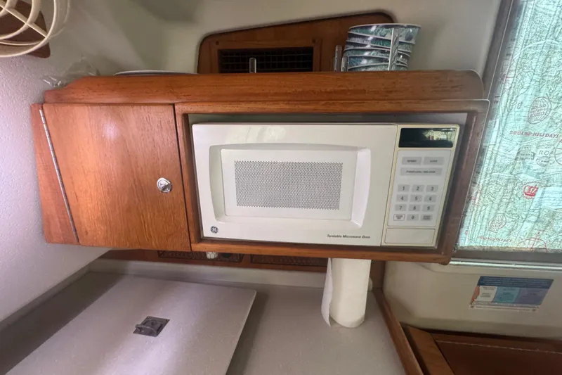 True Love Yacht Photos Pics Microwave in 2005 Catalina Morgan 440 DS yacht kitchen with wooden cabinetry.