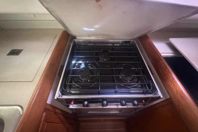 True Love Yacht Photos Pics Stove in 2005 Catalina Morgan 440 DS yacht kitchen, featuring three burners.