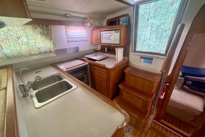 True Love Yacht Photos Pics 2005 Catalina Morgan 440 DS yacht kitchen with sink, stove, and microwave.