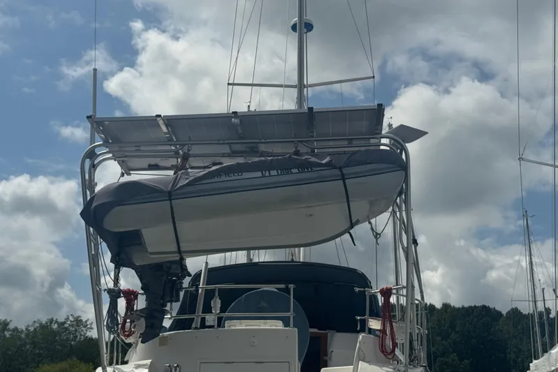 True Love Yacht Photos Pics 2005 Catalina Morgan 440 DS with dinghy and solar panels under cloudy sky.