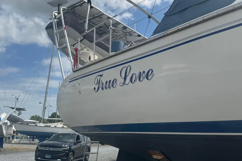 True Love Yacht Photos Pics Catalina Morgan 440 DS 2005 sailboat "True Love" docked with a car nearby.
