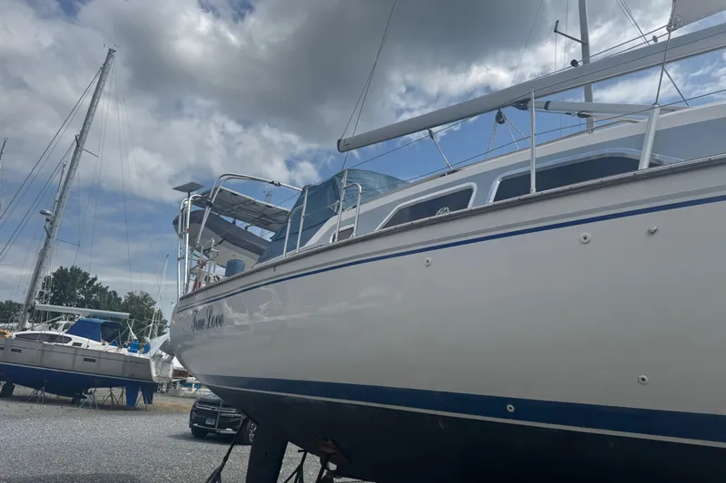 True Love Yacht Photos Pics 2005 Catalina Morgan 440 DS sailboat on land under cloudy sky.