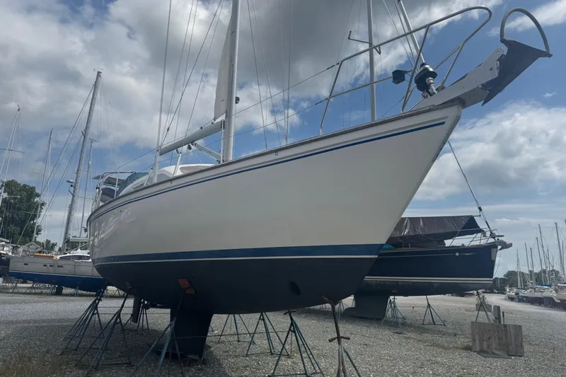 True Love Yacht Photos Pics 2005 Catalina Morgan 440 DS sailboat on stands, cloudy sky background.