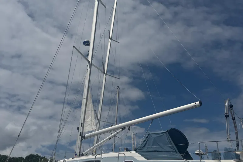True Love Yacht Photos Pics Sailboat mast of 2005 Catalina Morgan 440 DS against cloudy sky.