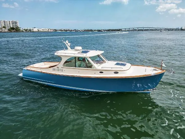  Yacht Photos Pics 2013 Hinckley Talaria 34 cruising on open water under a clear sky.