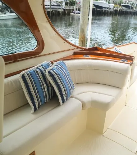  Yacht Photos Pics 2013 Hinckley Talaria 34 yacht interior with striped cushions and elegant seating.