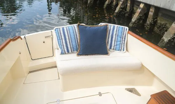  Yacht Photos Pics 2013 Hinckley Talaria 34 boat interior with striped cushions and seating area.