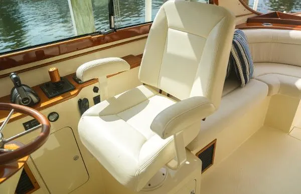  Yacht Photos Pics Luxurious interior of 2013 Hinckley Talaria 34 yacht with plush seating and helm.