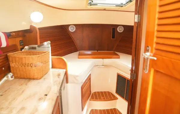  Yacht Photos Pics Interior of 2013 Hinckley Talaria 34 yacht with wooden finishes and cozy cabin space.