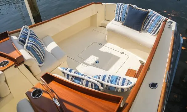  Yacht Photos Pics 2013 Hinckley Talaria 34 boat interior with striped cushions and wooden accents.