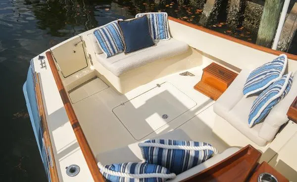  Yacht Photos Pics 2013 Hinckley Talaria 34 boat interior with striped cushions and wooden accents.