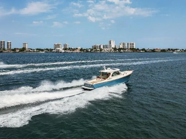  Yacht Photos Pics 2013 Hinckley Talaria 34 cruising on open water with city skyline in background.