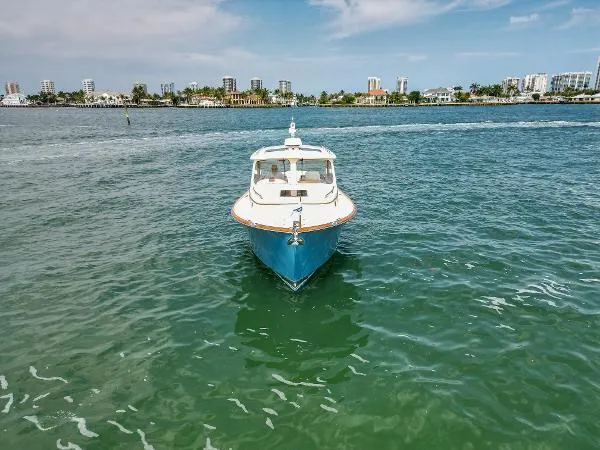  Yacht Photos Pics Hinckley Talaria 34 boat on calm water, city skyline in background, 2013 model.