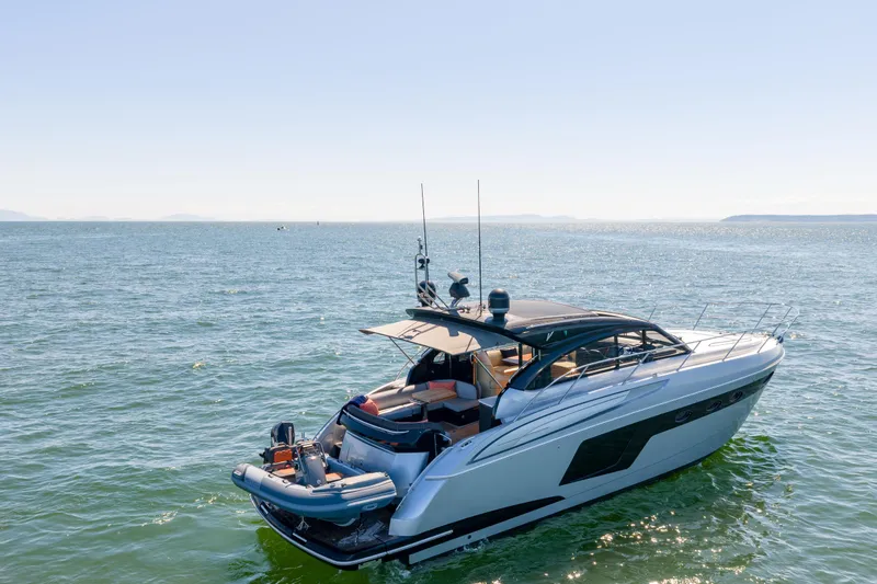  Yacht Photos Pics Luxury 2015 Princess V48 yacht cruising on open sea under clear blue sky.