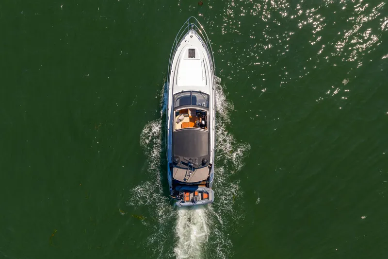  Yacht Photos Pics Overhead view of 2015 Princess V48 yacht cruising on green water.