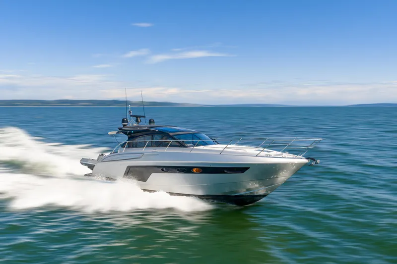  Yacht Photos Pics 2015 Princess V48 yacht cruising on open water under clear blue skies.