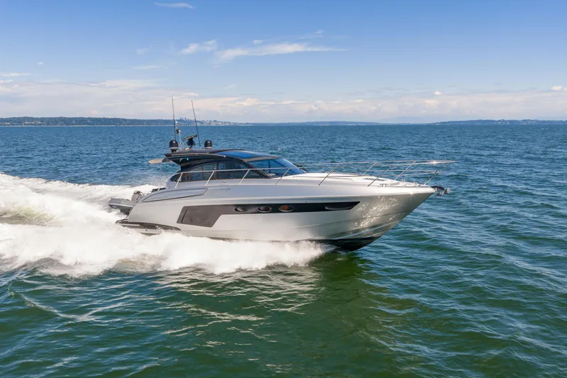  Yacht Photos Pics 2015 Princess V48 yacht cruising on open water under clear skies.