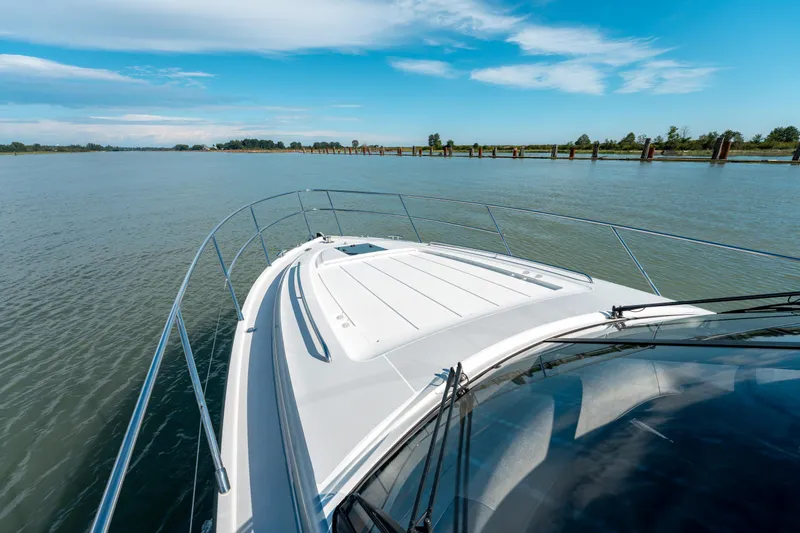  Yacht Photos Pics 2015 Princess V48 yacht cruising on a calm river under a clear blue sky.