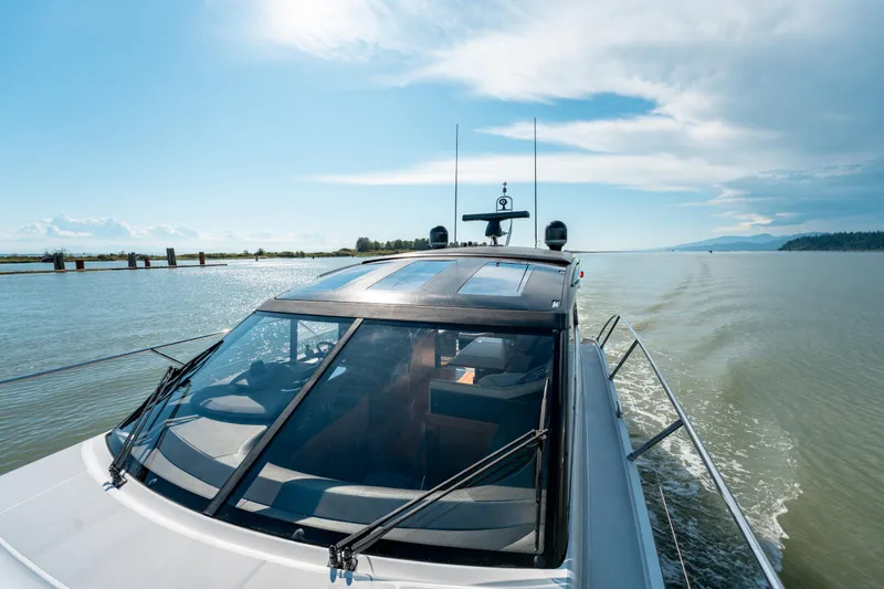  Yacht Photos Pics 2015 Princess V48 yacht cruising on a sunny day, scenic waterway view.