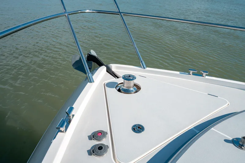  Yacht Photos Pics Bow of 2015 Princess V48 yacht with stainless steel railings on calm water.