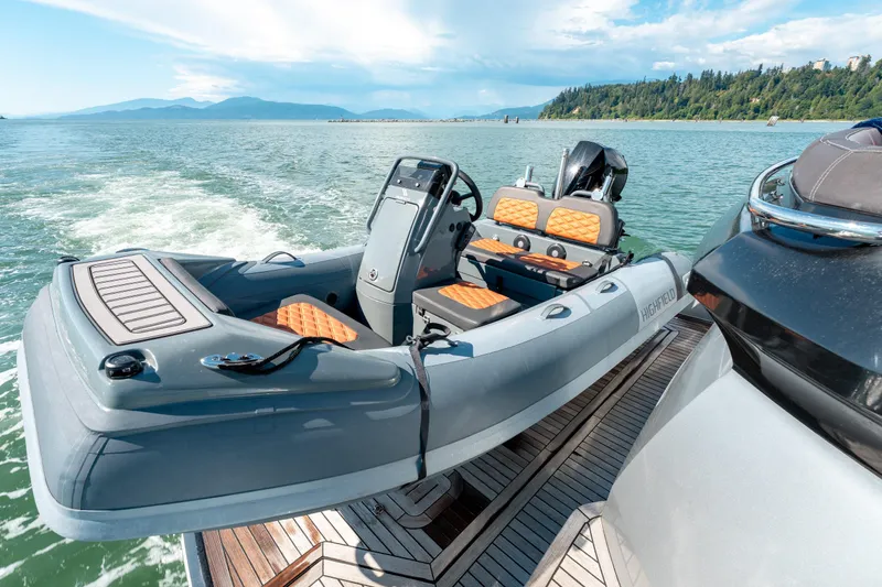  Yacht Photos Pics Luxury 2015 Princess V48 yacht with inflatable tender on scenic water.