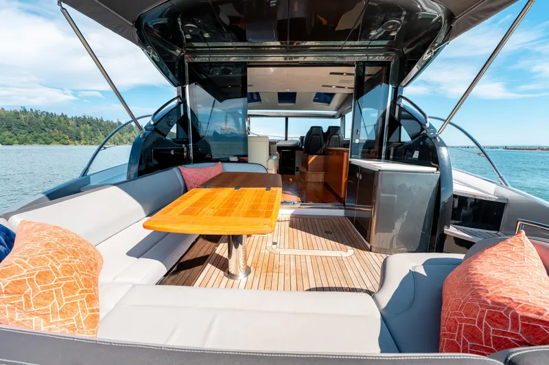  Yacht Photos Pics Luxurious 2015 Princess V48 yacht interior with elegant seating and wooden table on open water.