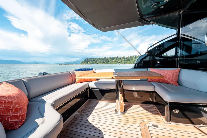  Yacht Photos Pics Luxurious 2015 Princess V48 yacht deck with seating, table, and scenic ocean view.