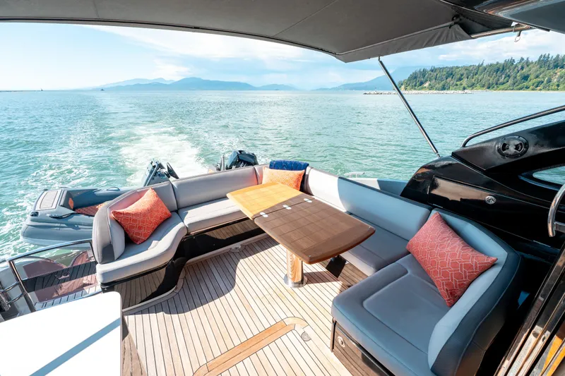  Yacht Photos Pics Luxurious 2015 Princess V48 yacht deck with seating, table, and scenic ocean view.