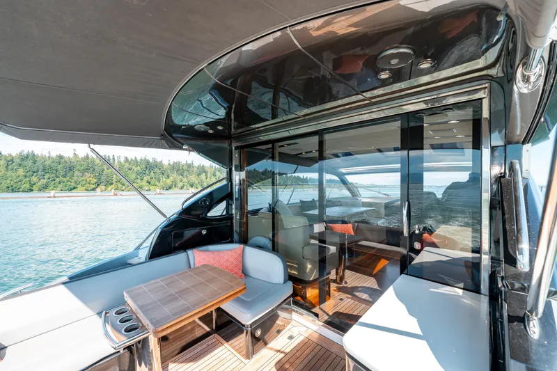  Yacht Photos Pics Luxurious 2015 Princess V48 yacht with elegant outdoor seating and scenic water view.