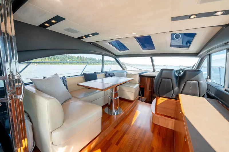  Yacht Photos Pics Luxurious interior of 2015 Princess V48 yacht with leather seating and panoramic windows.